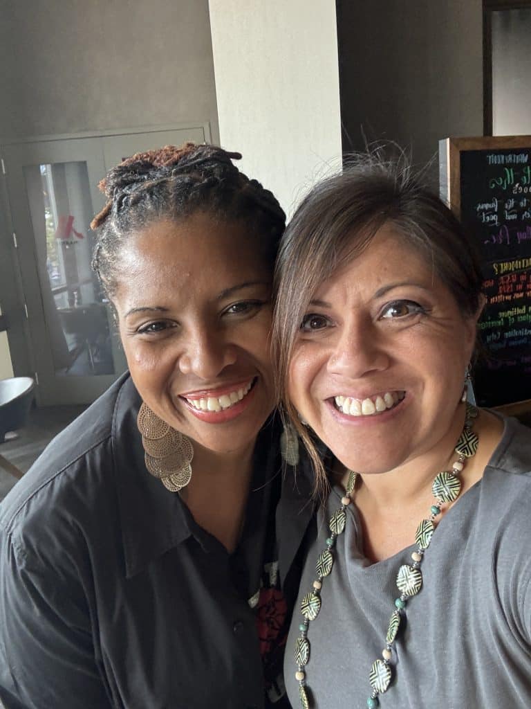 Two women smiling- Wendie Veloz with client PerCilla Zeno, owner of Zeno Wellness Group.