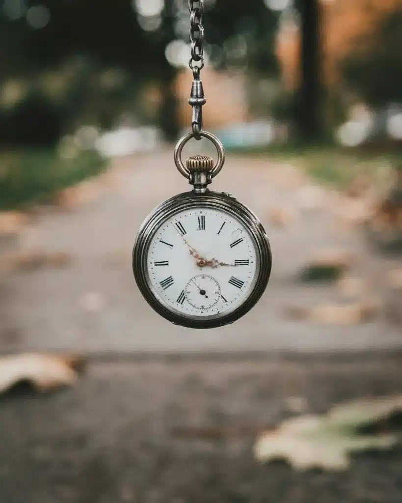 stop watch floating in front of a street.